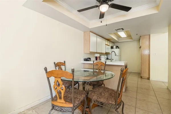 a view of a dining room with furniture and a chandelier fan