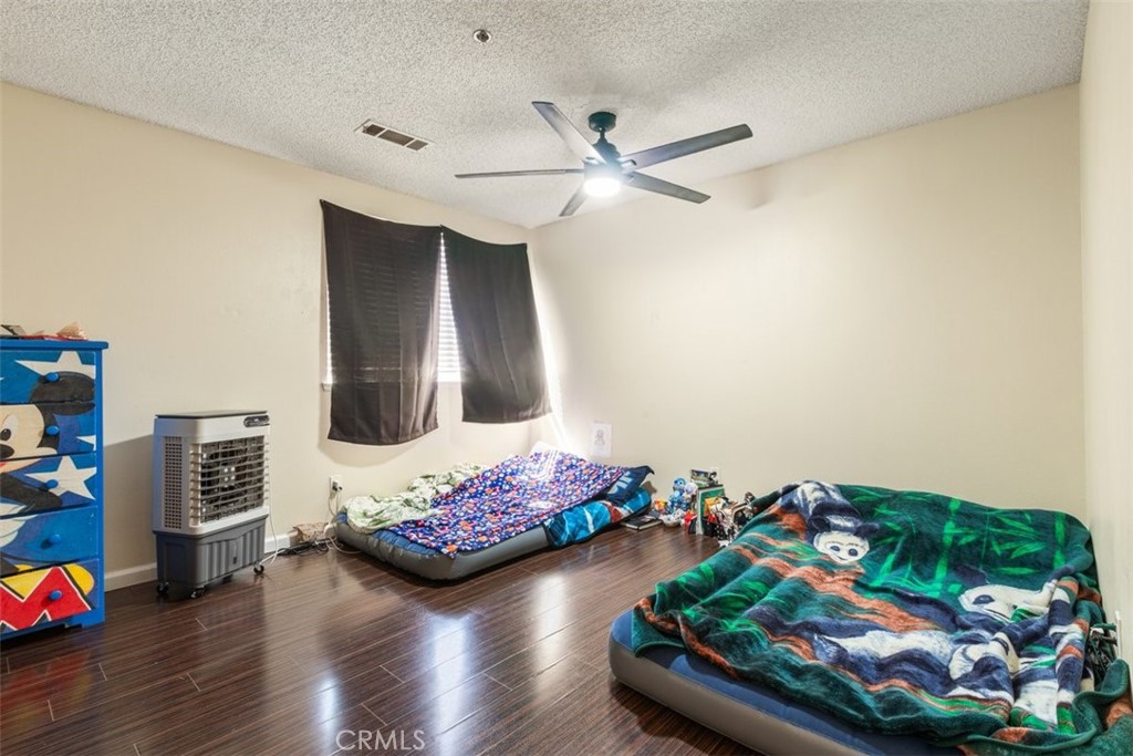 44544 15th Street East, Unit 9 Lancaster, CA 93535 - Photo 9 of 18 a living room with furniture and a wooden floor