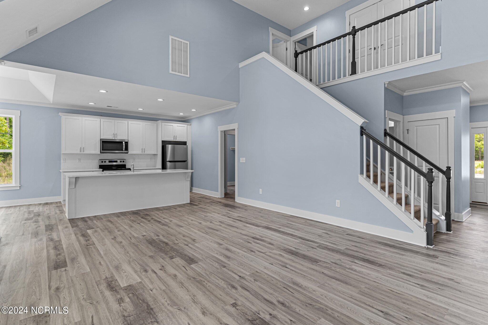 520 Barber Road Boiling Spring Lakes, NC 28461 - Photo 8 of 34 Large open 2 story living room with open kitchen and separate dining or sun room.