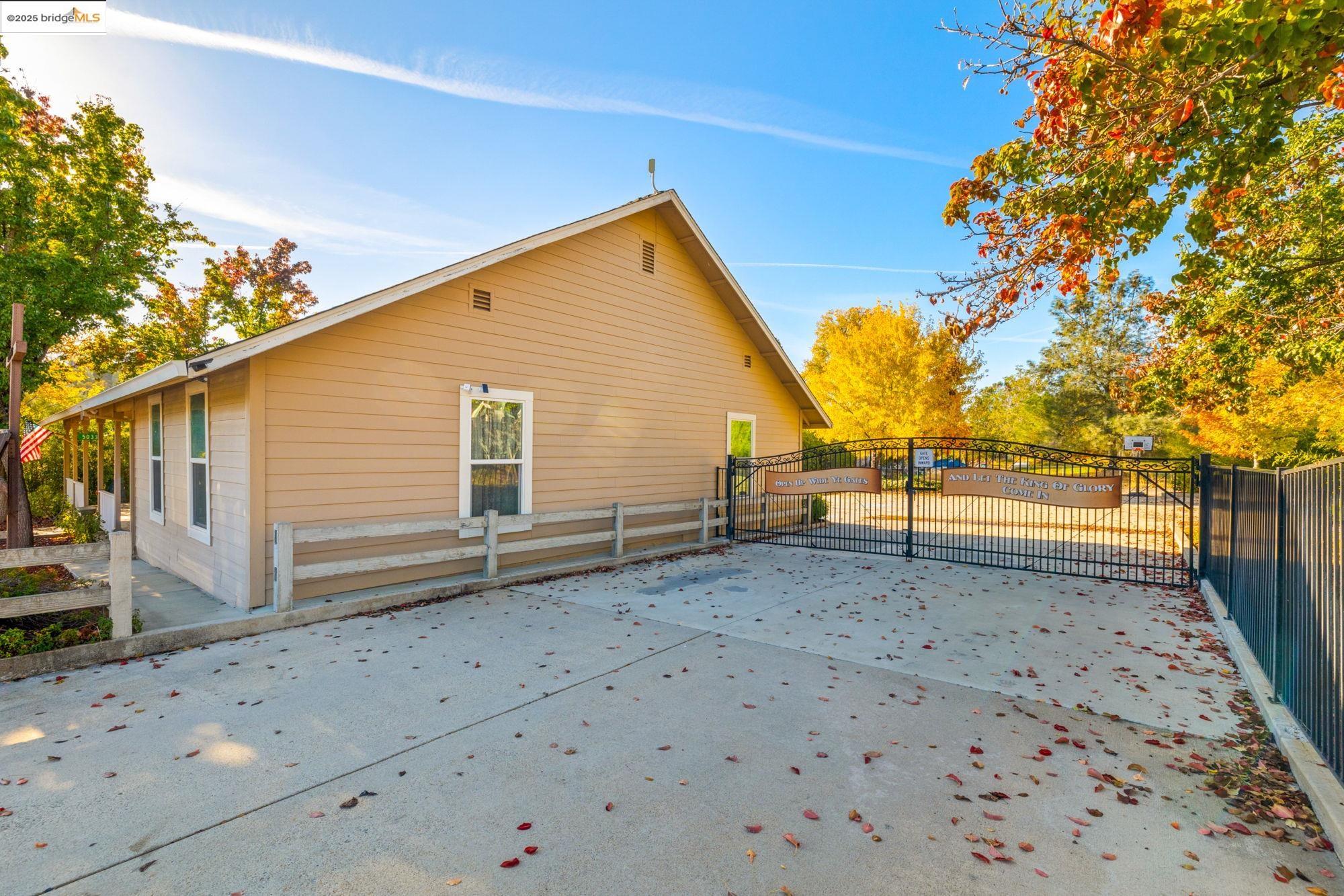 5033 Main Street Coulterville, CA 95311 - Photo 14 of 38 Rear view of house with a gate and a patio area