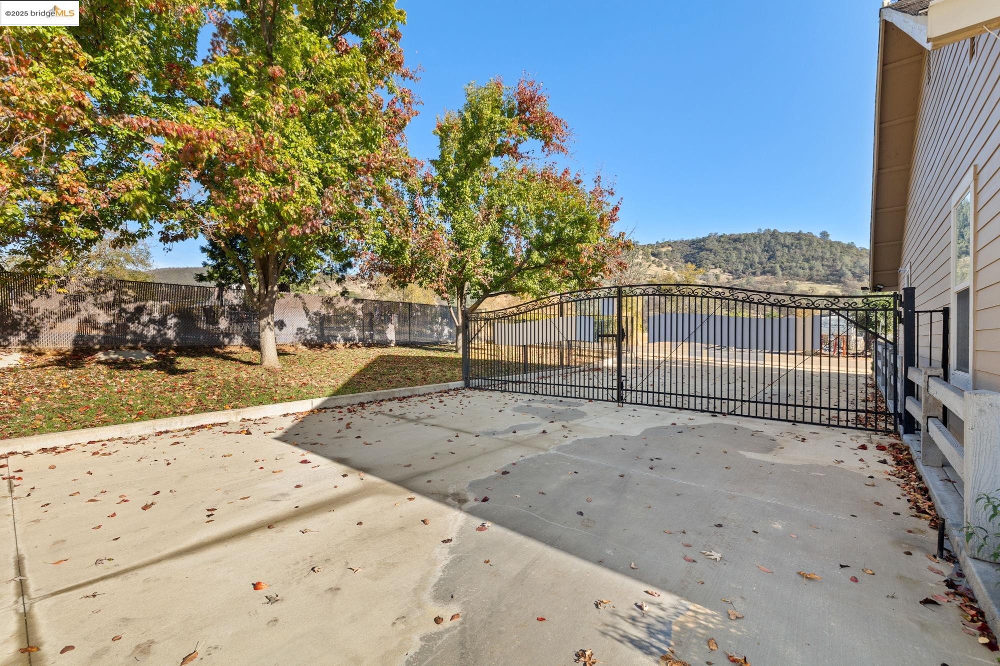 5033 Main Street Coulterville, CA 95311 - Photo 16 of 38 Gate with a fenced backyard and a patio