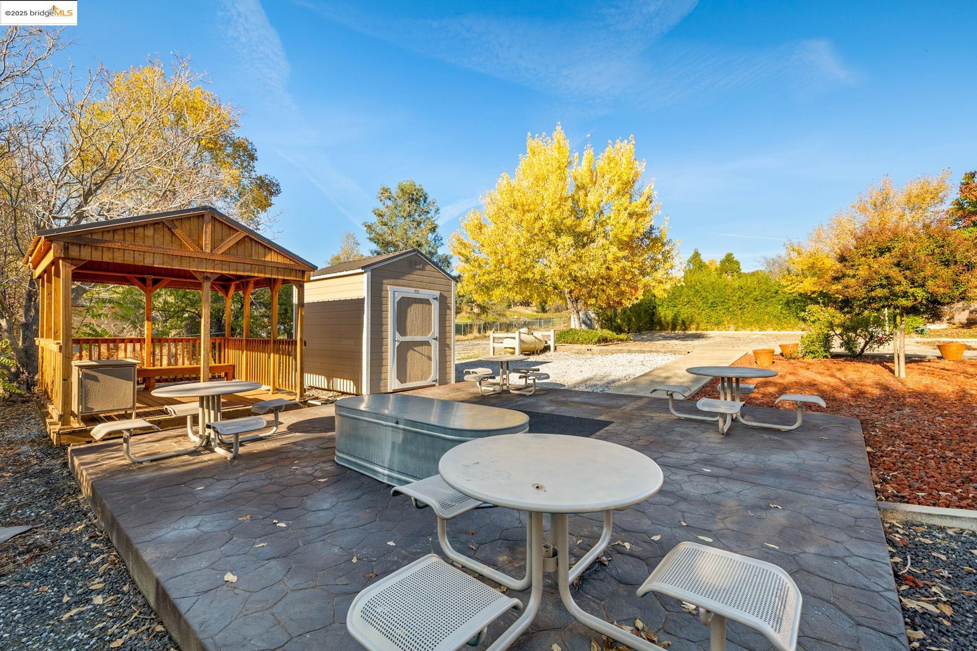 5033 Main Street Coulterville, CA 95311 - Photo 18 of 38 View of patio / terrace featuring a storage shed and outdoor dining space