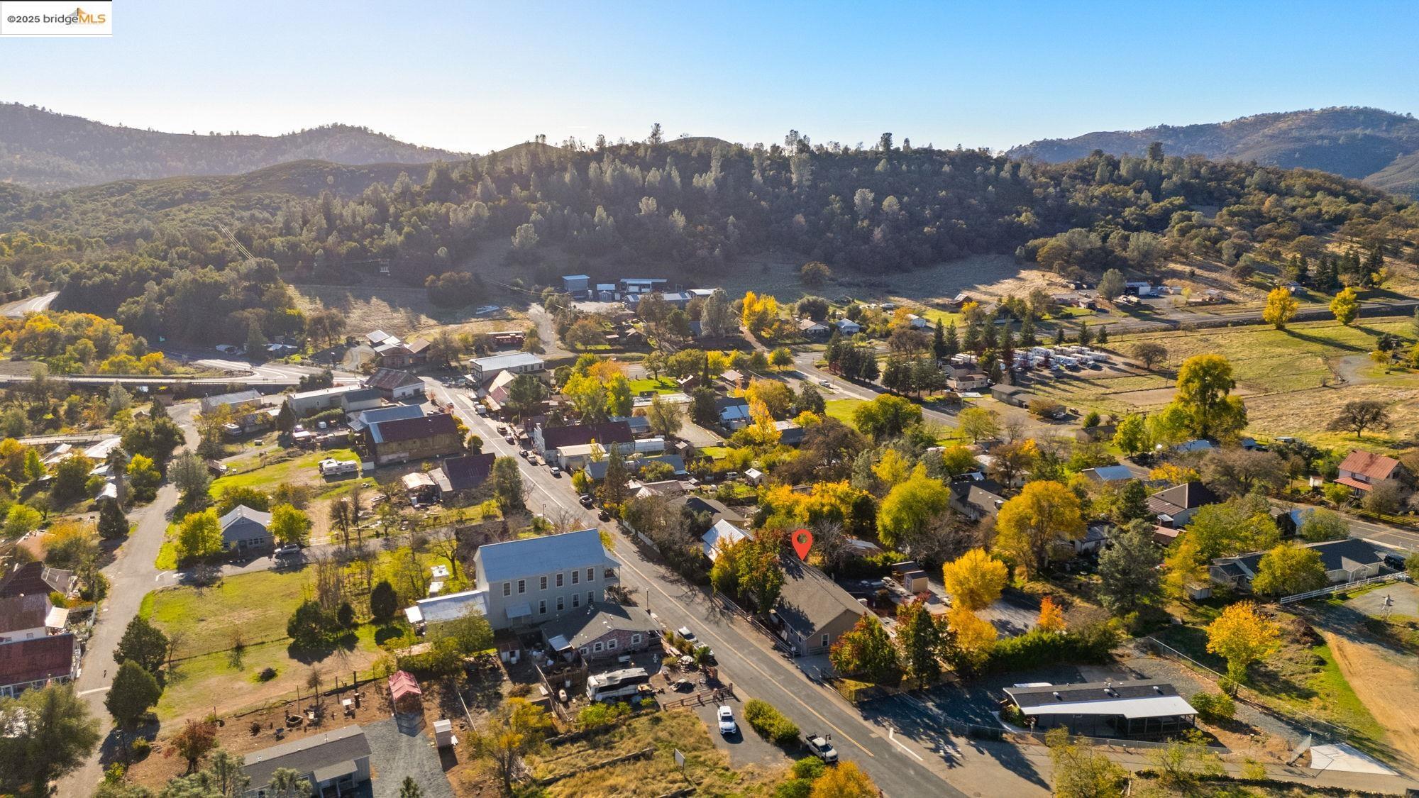 5033 Main Street Coulterville, CA 95311 - Photo 6 of 38 Aerial view of property and surrounding area featuring a mountain backdrop