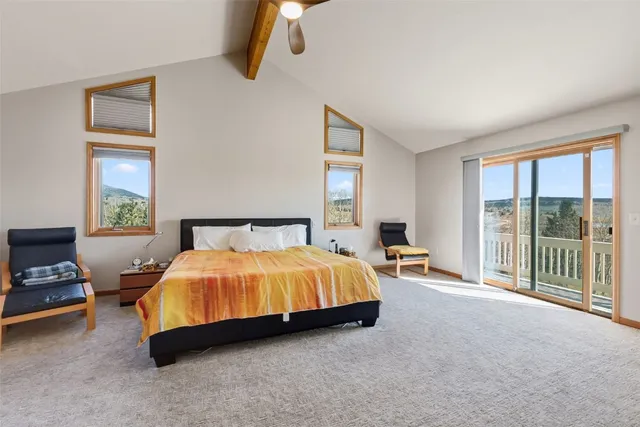 a spacious bedroom with a bed and large window