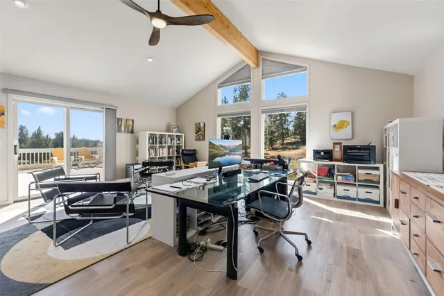 a view of a workspace with furniture and a window
