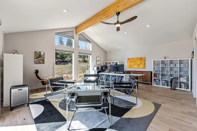 a living room with furniture a rug and a table