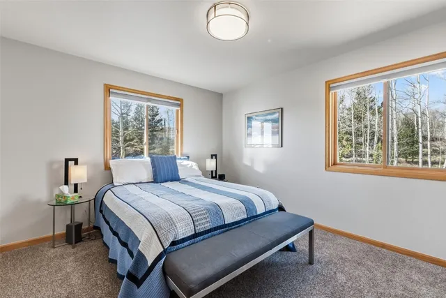a bedroom with a bed lamp and window