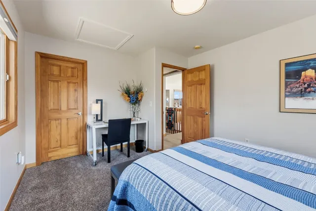 a bedroom with a bed and a table in it