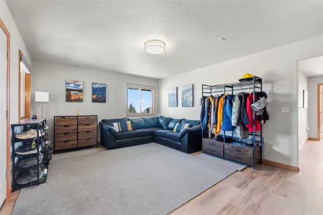 a living room with furniture and gym equipment