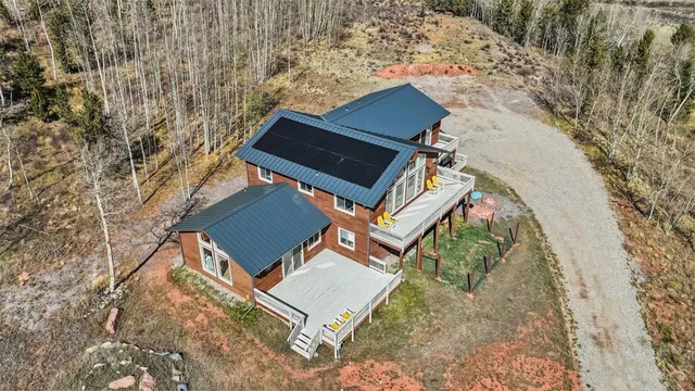 an aerial view of a house with a yard