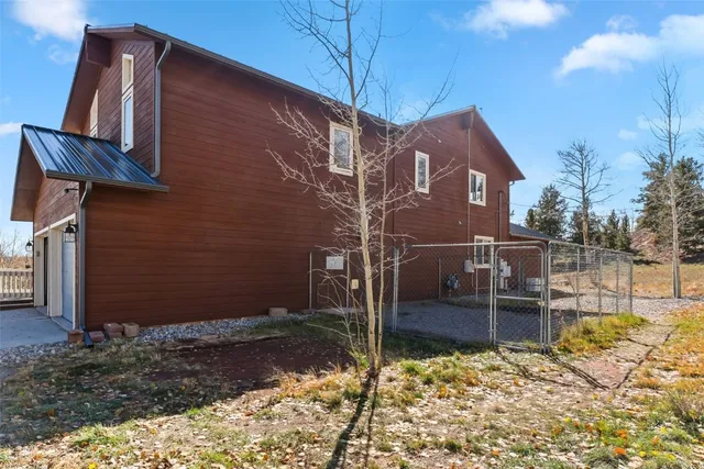 a brick building with a large tree in front