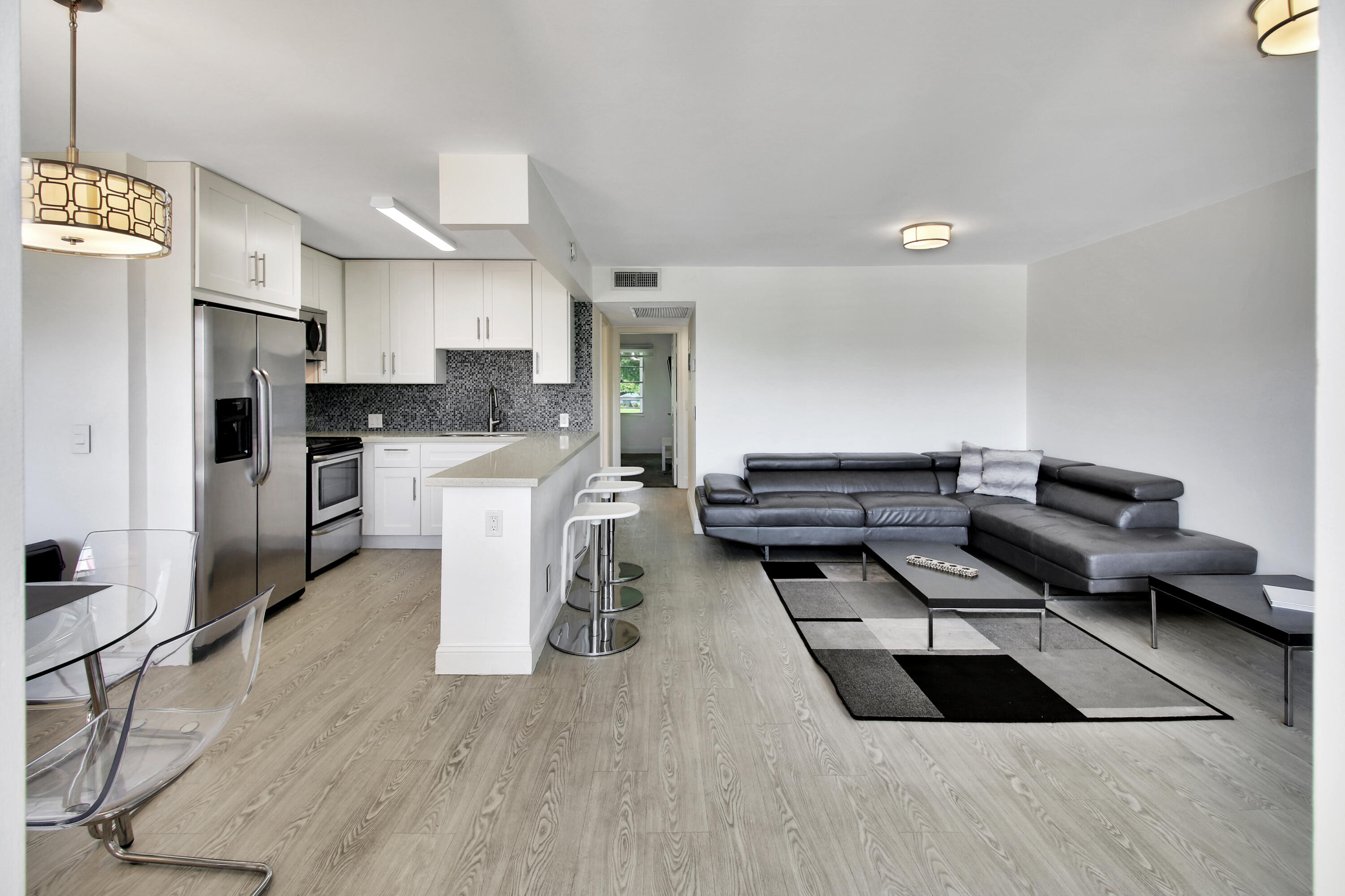 a kitchen with stainless steel appliances kitchen island granite countertop a refrigerator and a stove top oven