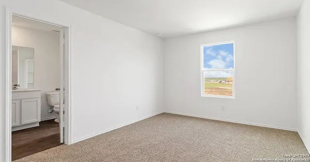 a view of an empty room and a window