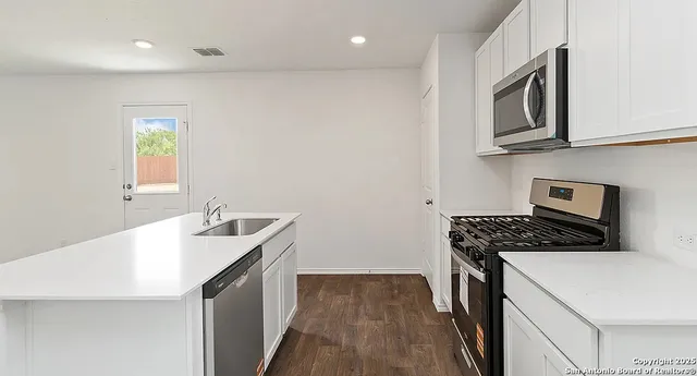 a kitchen that has a sink and a stove