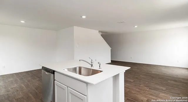 a kitchen with a sink and cabinets