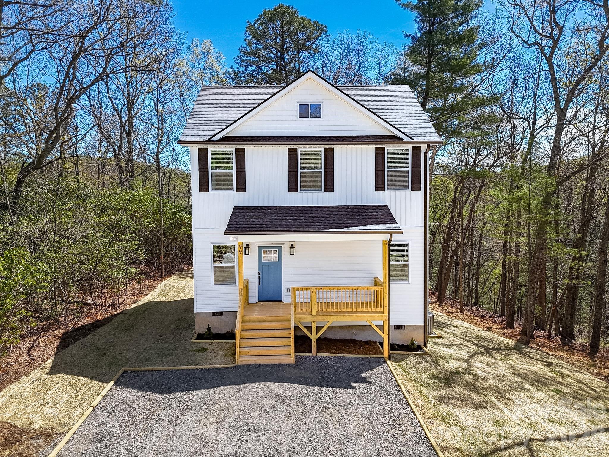 99 Lee Dotson Road Fairview, NC 28730 - Photo 1 of 47 a front view of a house with a yard