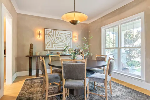 a view of a room with a chandelier furniture and windows