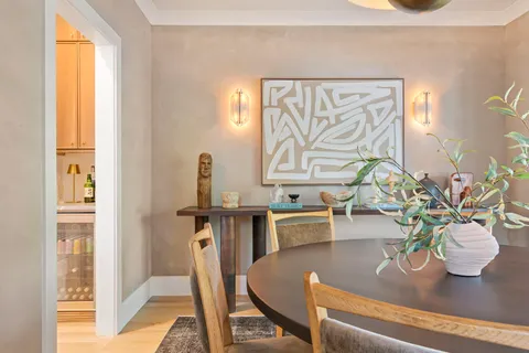 a view of a hallway with wooden floor and a bathroom