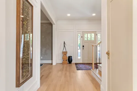 a bathroom with a granite countertop sink mirror and a shower