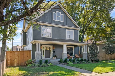 a front view of a house with a yard table and chairs