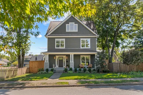 a front view of a house with potted plants
