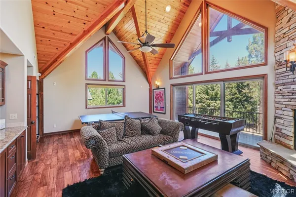 a living room with furniture and a floor to ceiling window
