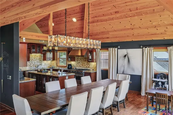 a dining room with lots of wooden furniture