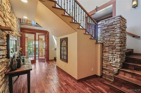 a living room with fireplace furniture and a large window