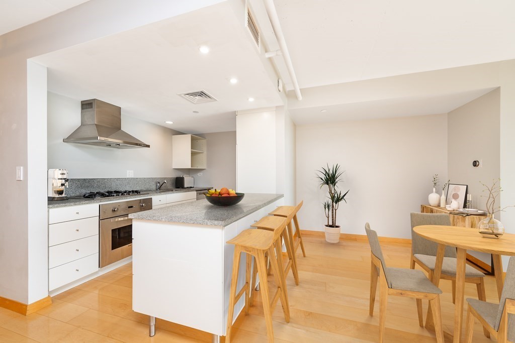 25 Channel Center Street, Unit 202 Boston, MA 02210 - Photo 2 of 18 a kitchen that has a lot of white cabinets and stainless steel appliances