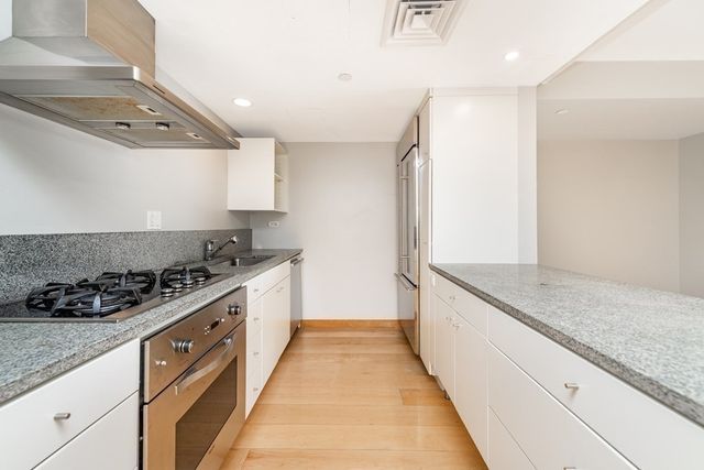 a kitchen with stainless steel appliances granite countertop a stove and a sink