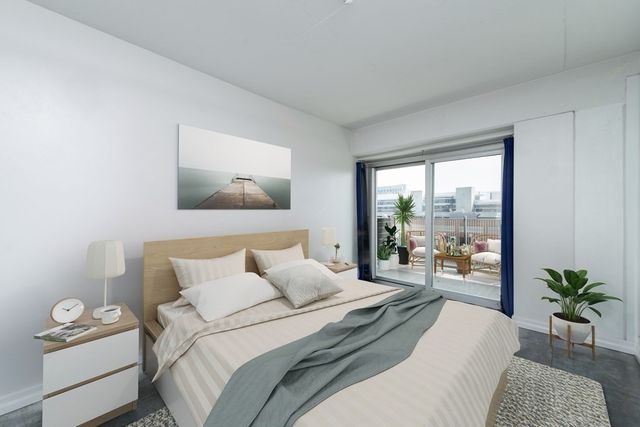 a bedroom with a bed and a large window