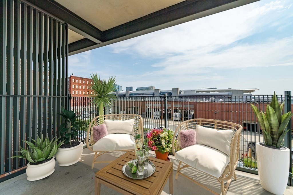 25 Channel Center Street, Unit 202 Boston, MA 02210 - Photo 5 of 18 a balcony with furniture and potted plants