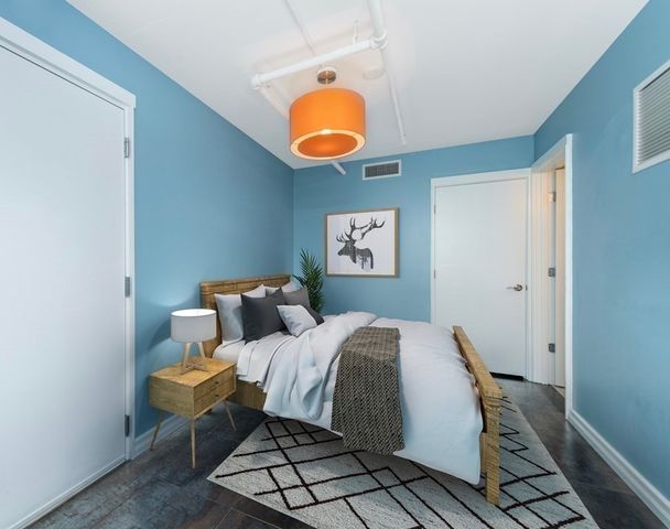 a bedroom with a bed and lamp