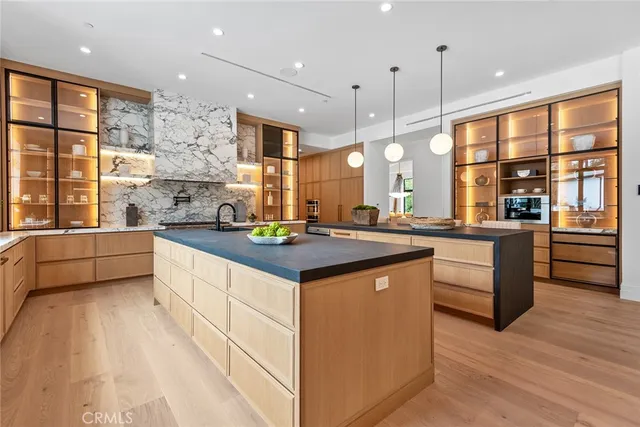 a large kitchen with a large counter top appliances and cabinets