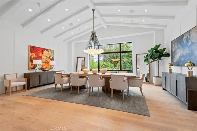 a living room with furniture a flat screen tv and a large window