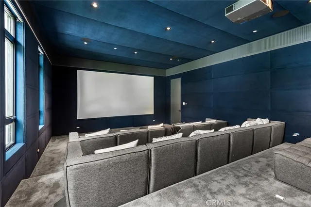 a media room with lots of chairs and a projector