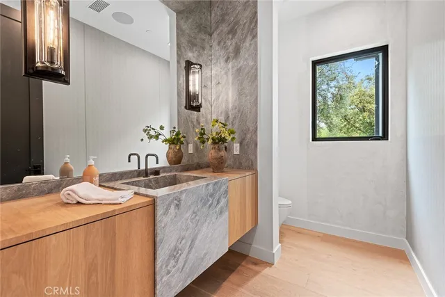 a bath room with a sink and a mirror