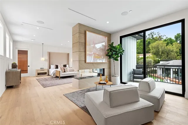 a living room with furniture and large windows