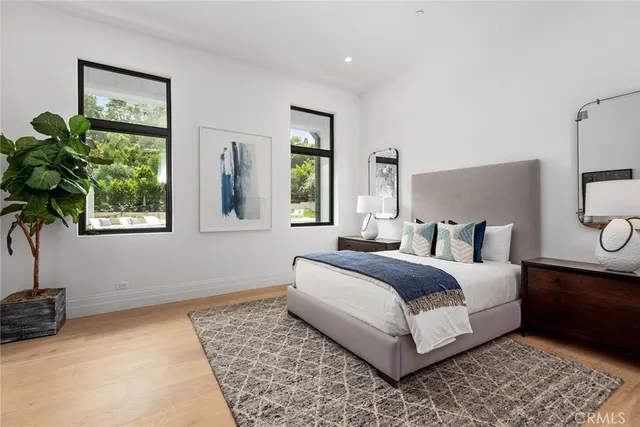 a bedroom with a bed lamp and a potted plant