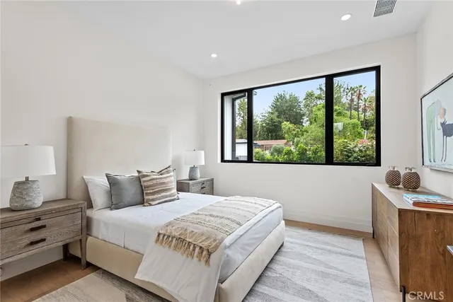 a bedroom with a large bed and a large window