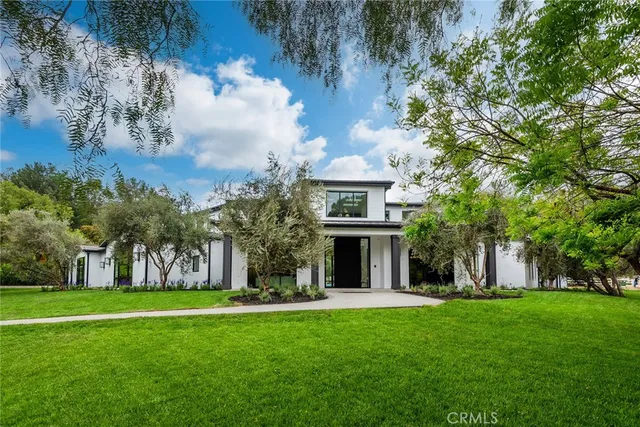 a front view of house with yard and green space