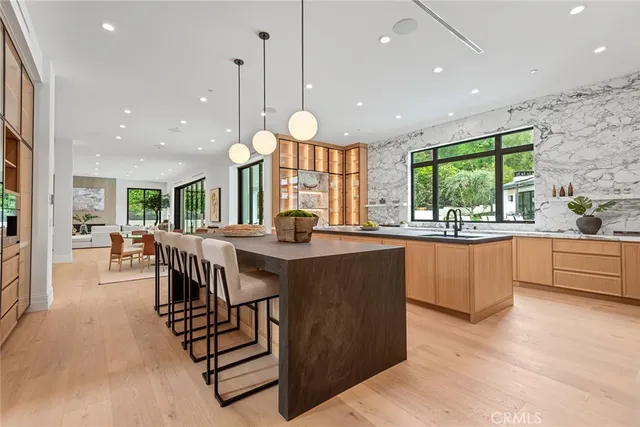 a kitchen with stainless steel appliances granite countertop sink stove and a wooden cabinets