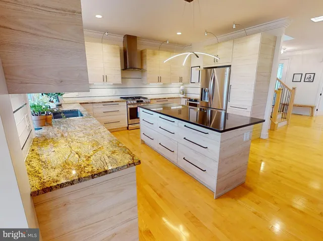 a kitchen with stainless steel appliances granite countertop a sink and counter space