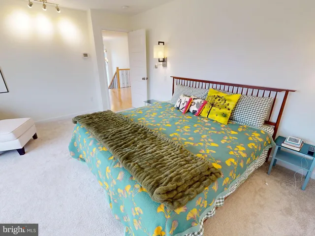 a bed sitting in a bedroom next to a bathroom