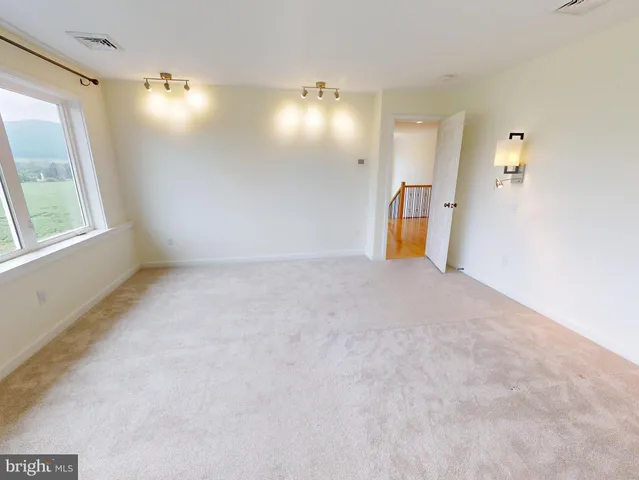 a view of empty room with a fireplace