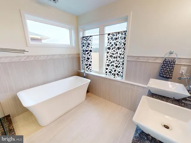 a bathroom with a bathtub sink and window