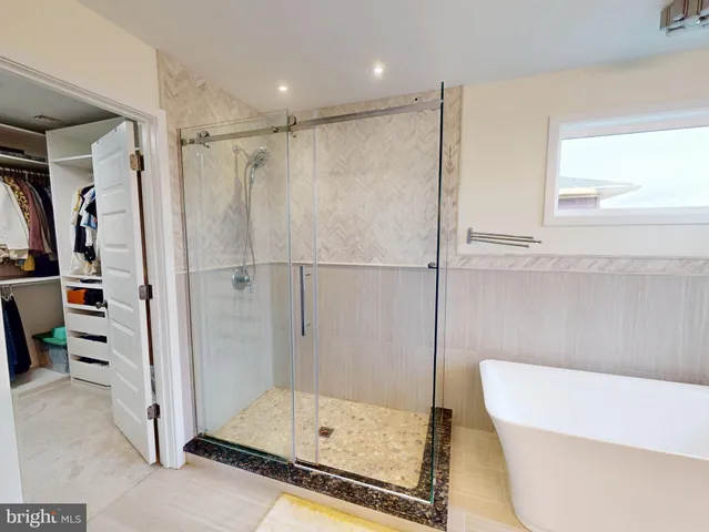 a bathroom with a bathtub and a shower
