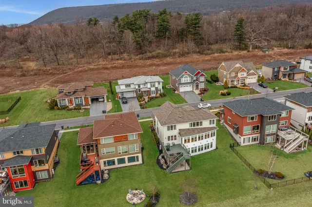 an aerial view of a house with outdoor space lake view and mountain view