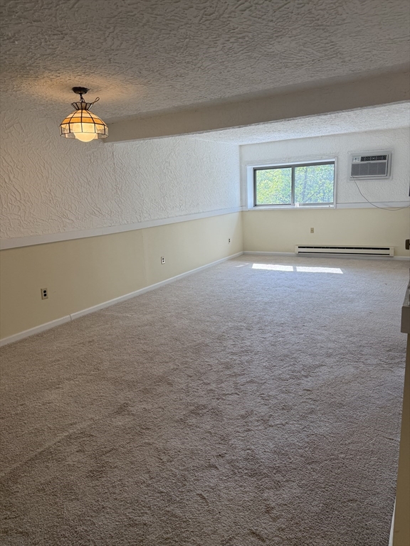 310 Codman Hill Road, Unit 34D Boxborough, MA 01719 - Photo 8 of 17 an empty room with a empty space and windows