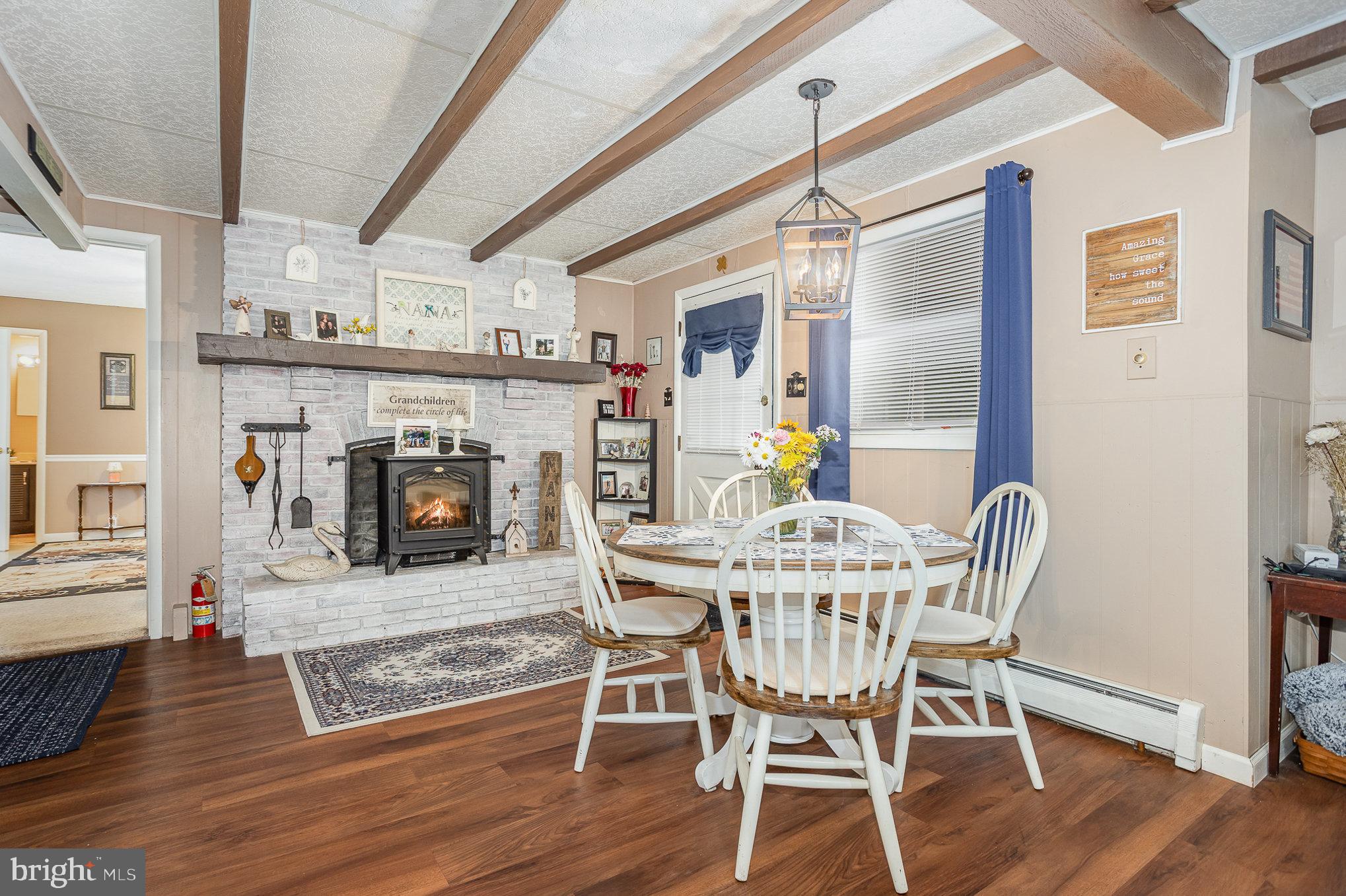 1243 Rawlinsville Road New Providence, PA 17560 - Photo 5 of 35 a view of a dining room with furniture wooden floor and a fireplace